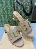GUCCI Matelassé Heeled Sandals – Gold-Tone Logo | White & Black
