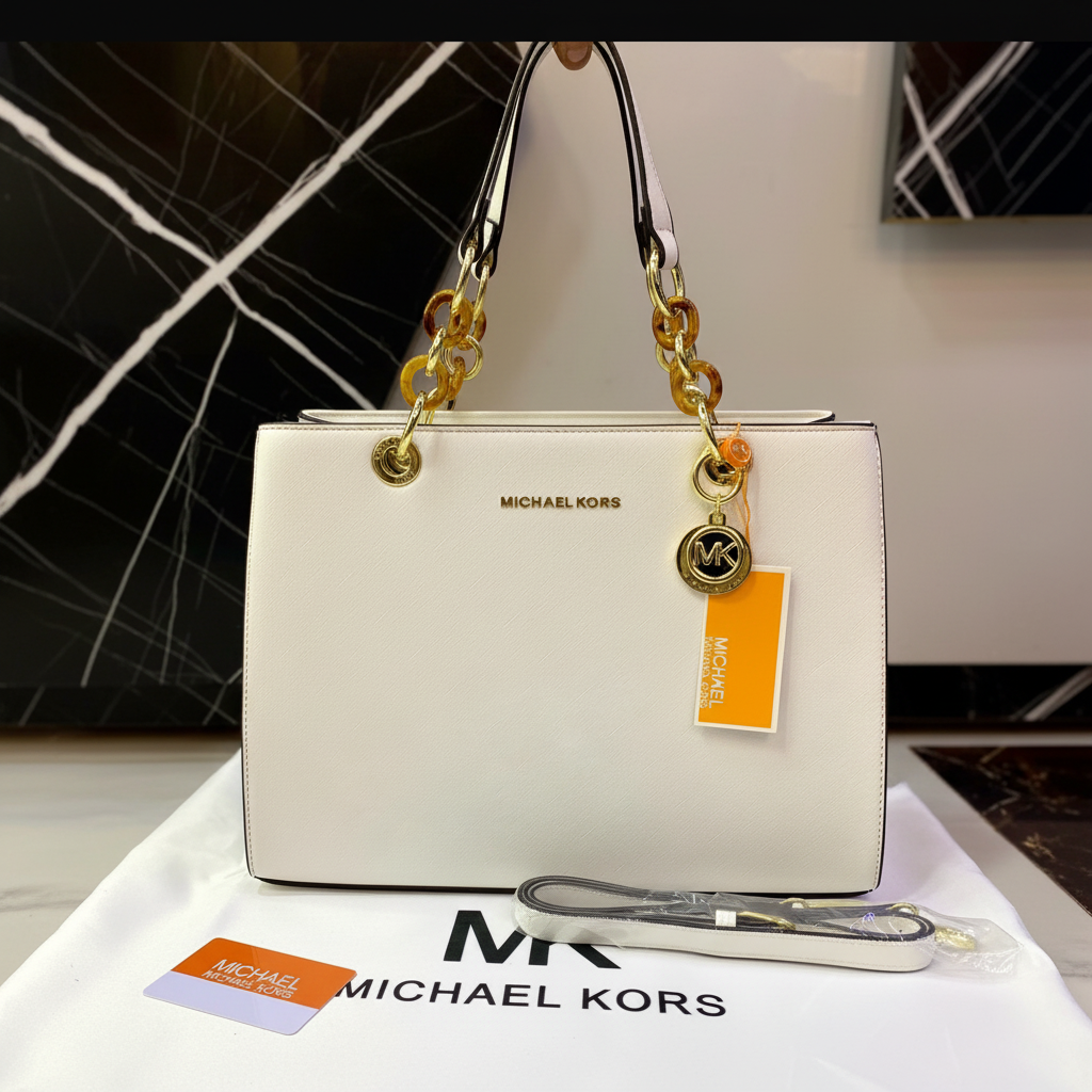 Michael Kors Signature Logo Tote Bag on white marble surface