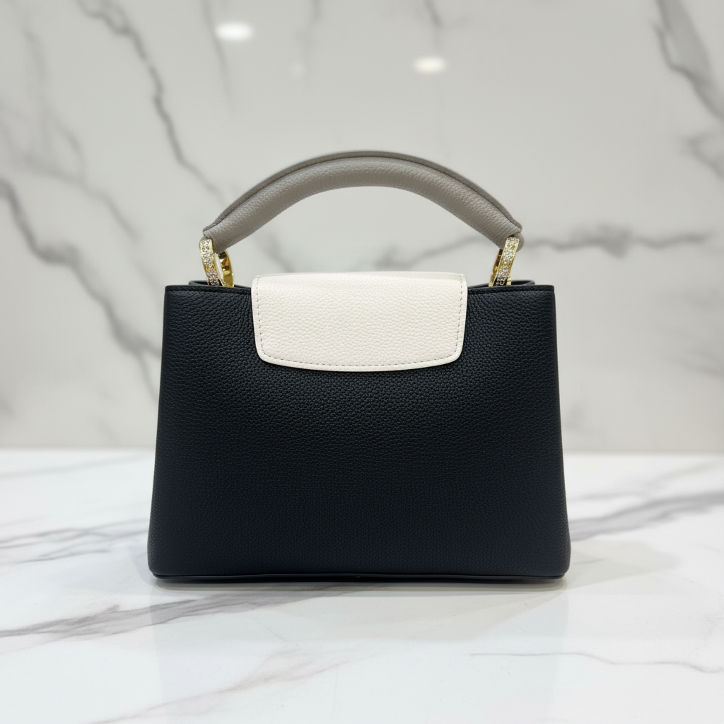 Louis Vuitton Capucines BB Black White Flap back view on white marble