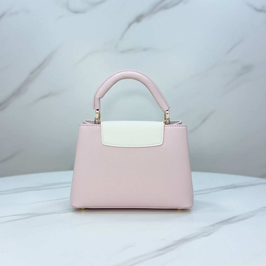Louis Vuitton Capucines Blush Pink back view on white marble