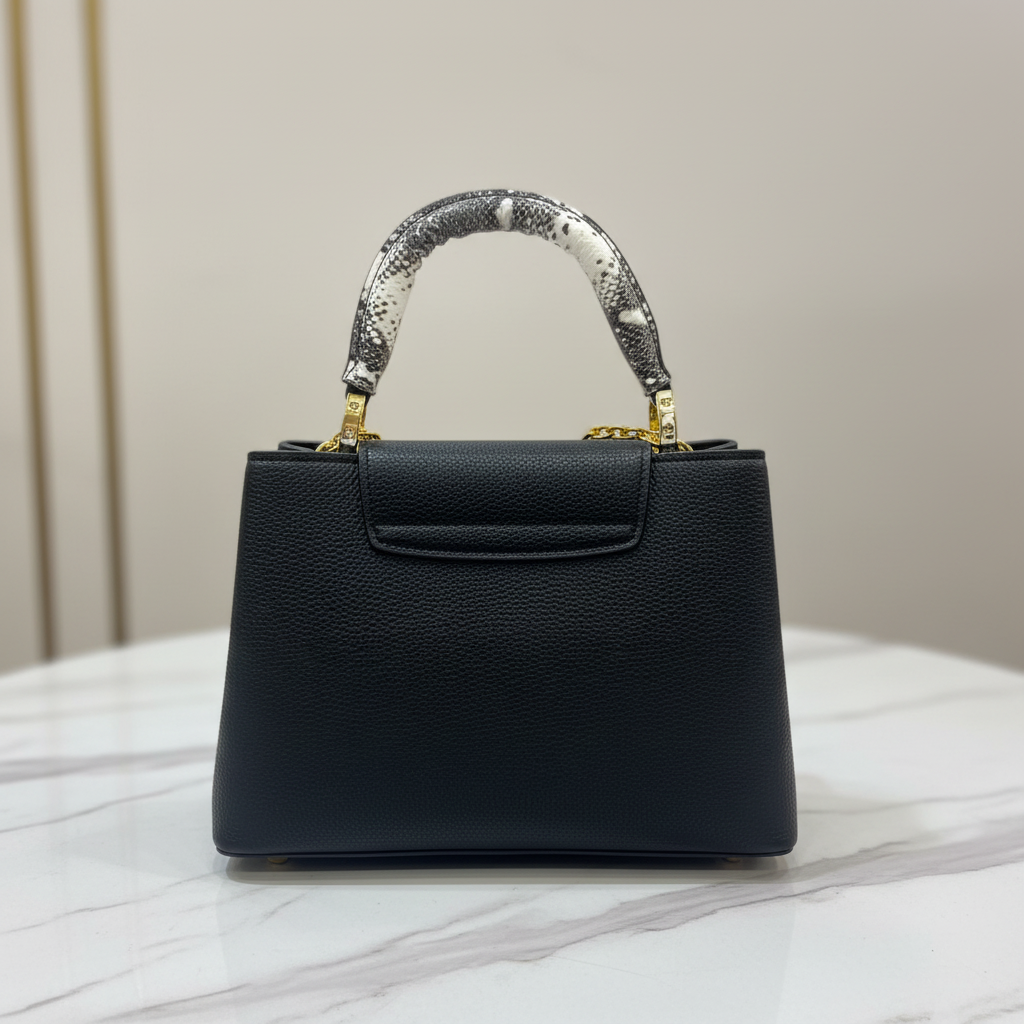 Louis Vuitton Capucines Black Python back view on white marble