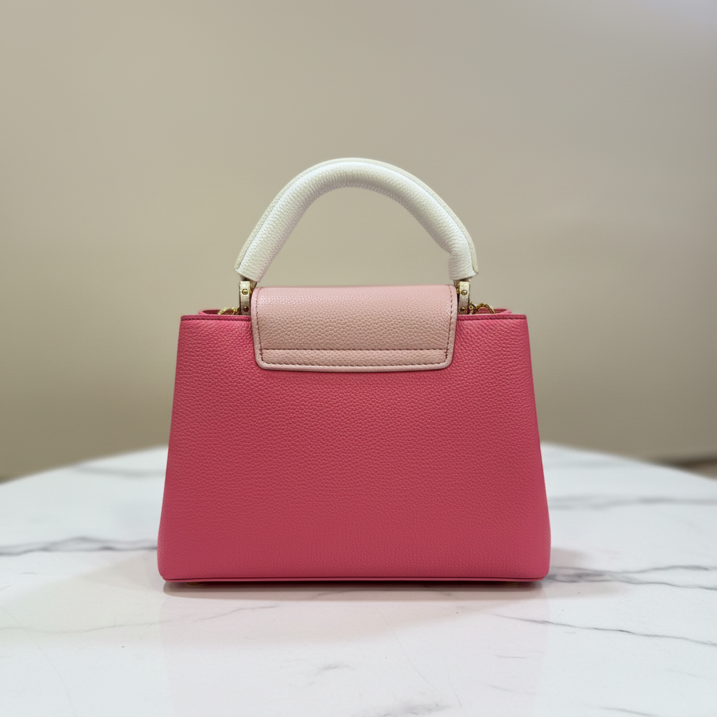 Louis Vuitton Capucines Hot Pink back view on white marble