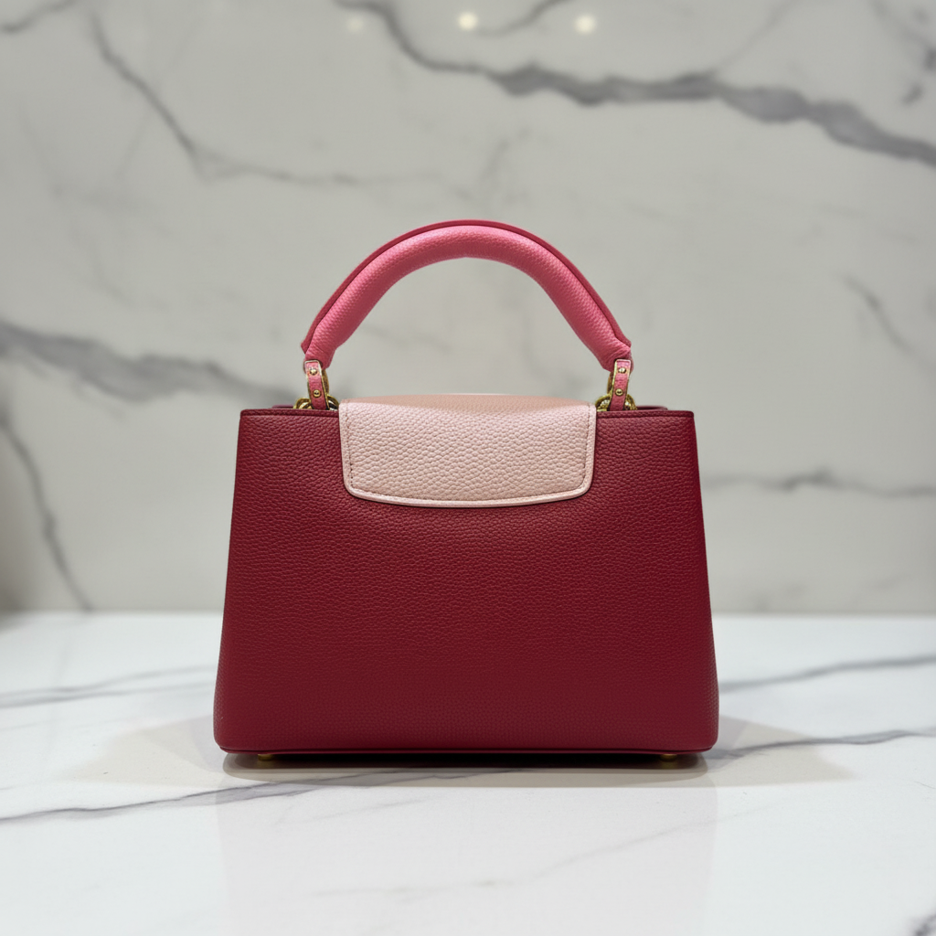 Louis Vuitton Capucines Deep Red back view on white marble