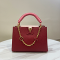 Louis Vuitton Capucines Deep Red LV logo reverse flap on white marble