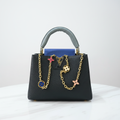 Louis Vuitton Capucines front view on white marble