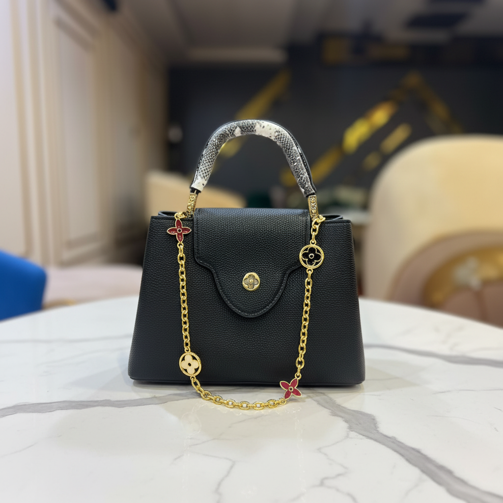 Louis Vuitton Capucines Black Python full chain charms view on white marble