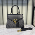 Coach Sammy Top Handle Bag on white marble surface