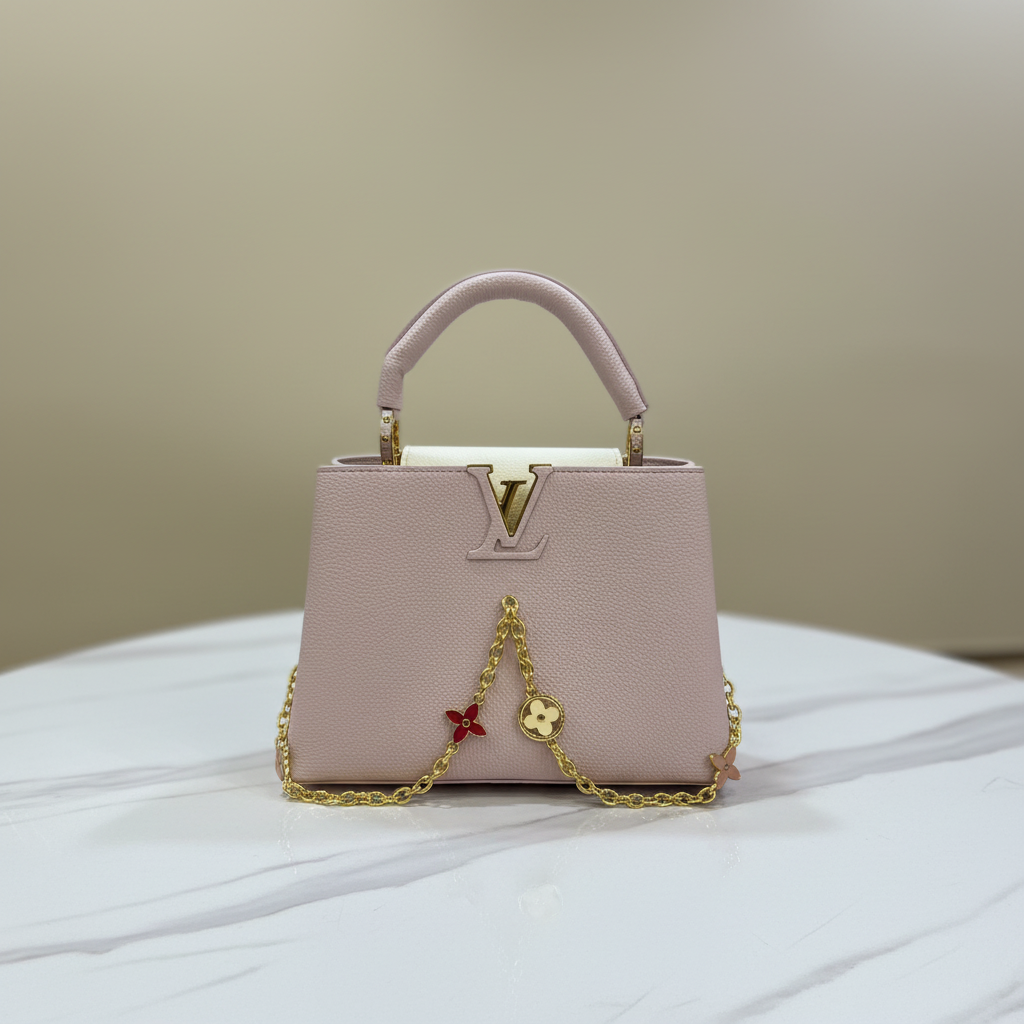 Louis Vuitton Capucines Blush Pink front LV logo on white marble
